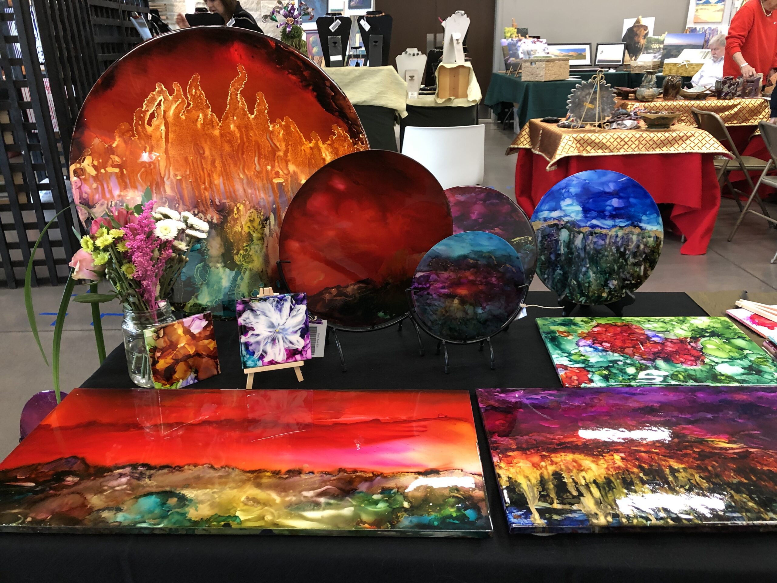 a table of colorful art including plates