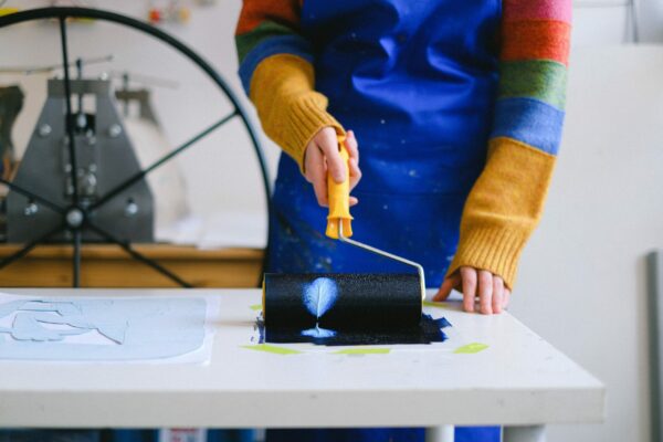 an artist uses a paint roller to create art